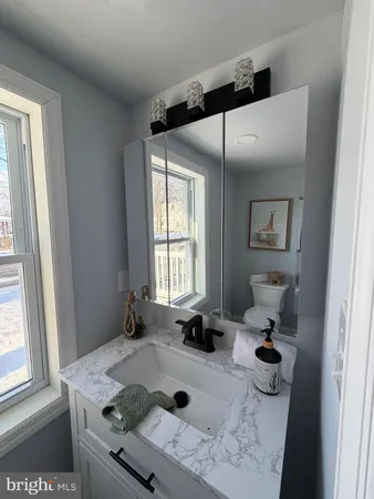a bathroom with a tub sink and mirror