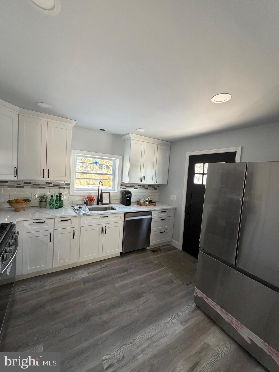 514 Race Street Palmyra, NJ 08065 - Photo 4 of 14 a kitchen with granite countertop white cabinets and white appliances