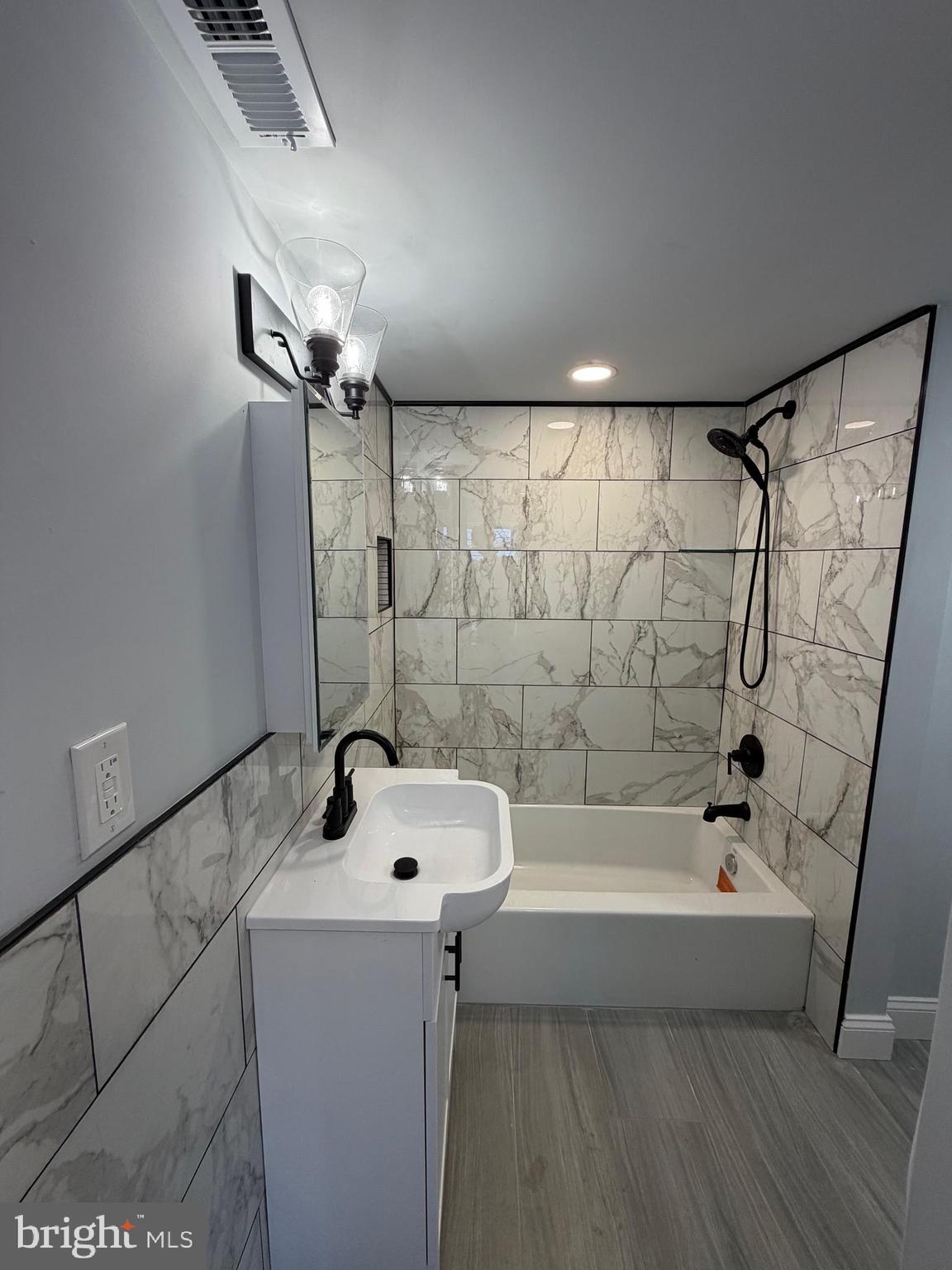 514 Race Street Palmyra, NJ 08065 - Photo 7 of 14 a bathroom with a bathtub a sink and a shower