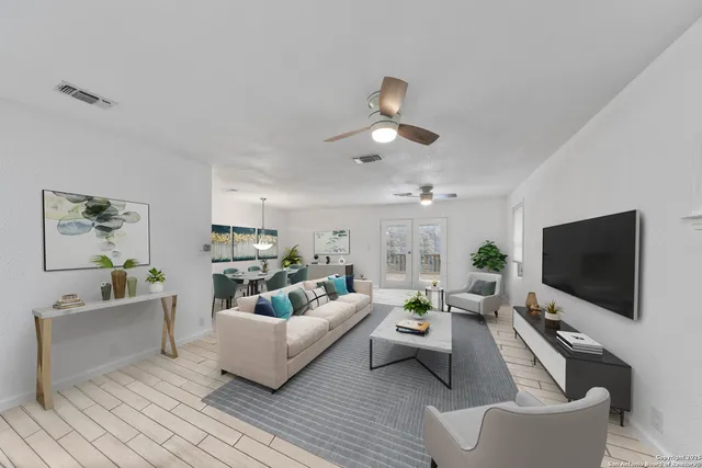 a living room with furniture and a flat screen tv