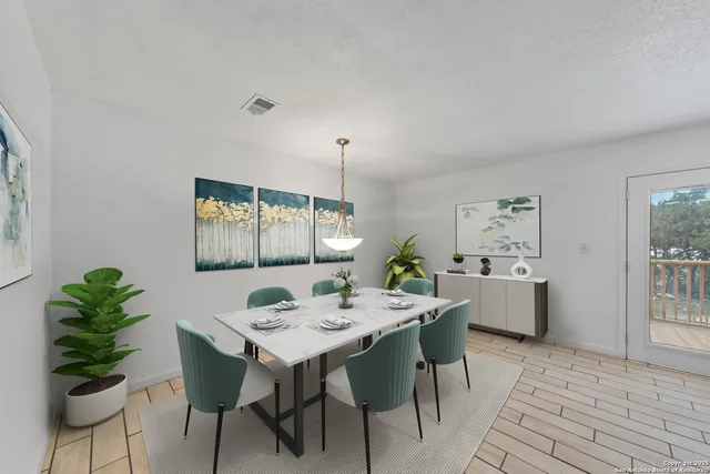 a view of a dining room that has a table and chairs in it