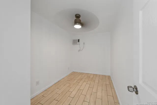 a view of a room with wooden floor
