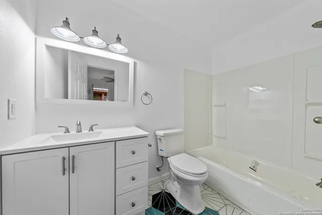 a bathroom with a toilet sink and mirror