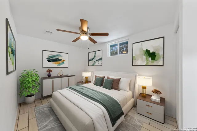 a bedroom with a bed and a painting on the wall