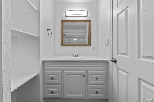 a bathroom with a sink mirror and