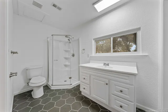a bathroom with a granite countertop toilet a sink and a bathtub