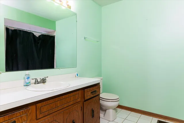 a bathroom with a sink a toilet and mirror
