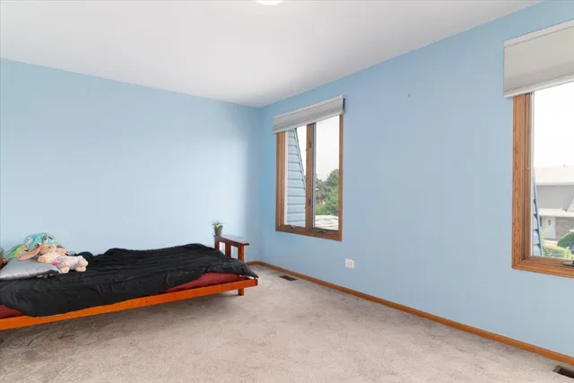 a bedroom with bed and window