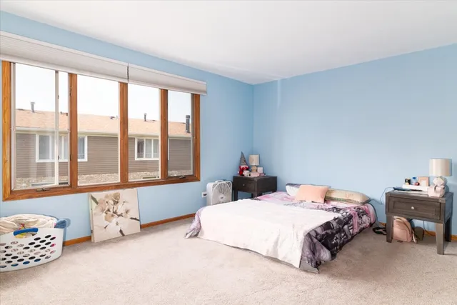 a bedroom with two beds and a large window