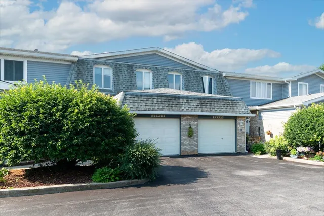a front view of house with a garden
