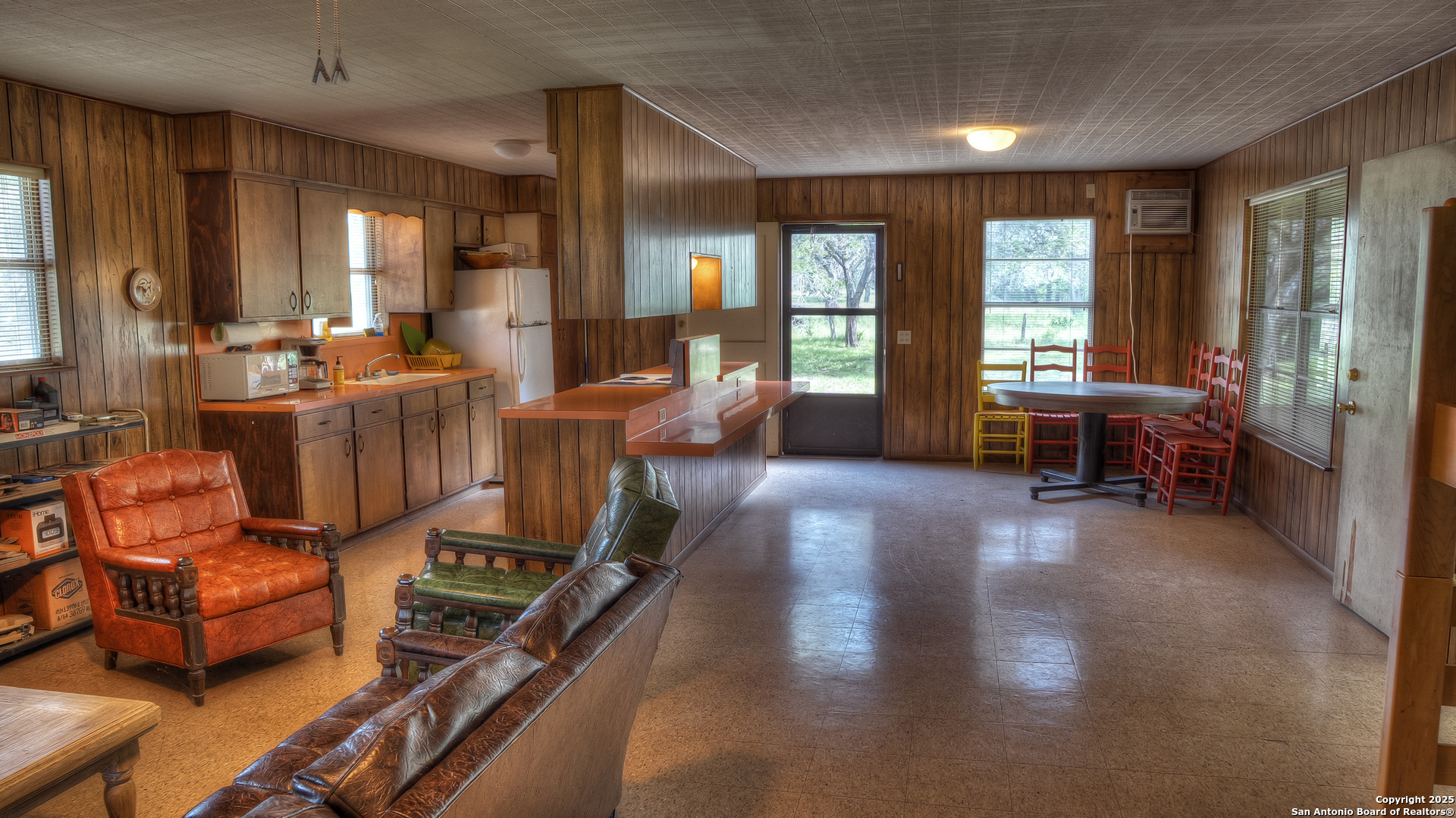 154 Weston Road Leakey, TX 78873 - Photo 22 of 39 a living room with furniture a large window and wooden floor