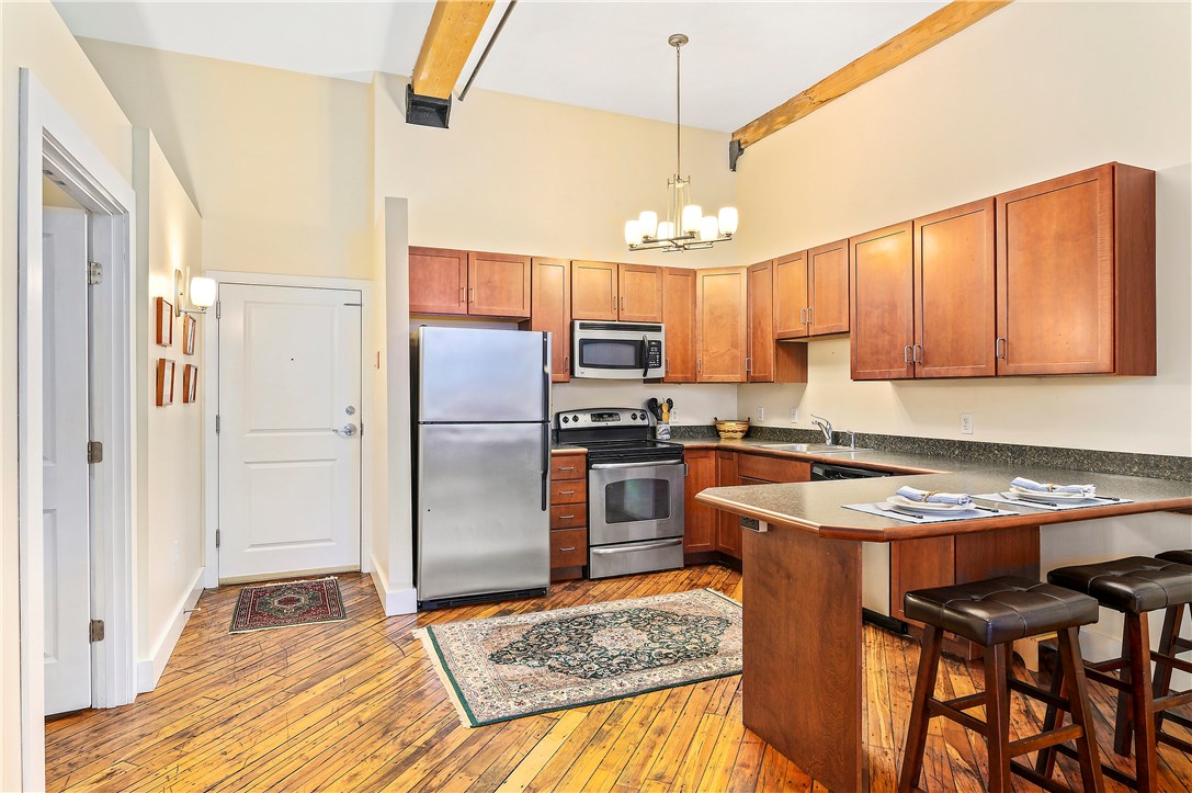 99 Allen Street, Unit 106 Woonsocket, RI 02895 - Photo 2 of 29 Fully applianced kitchen with refrigerator, range, dishwasher and microwave.