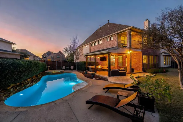 a view of a house with swimming pool and sitting area