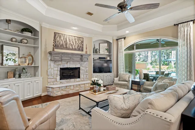a living room with furniture fireplace and a large window