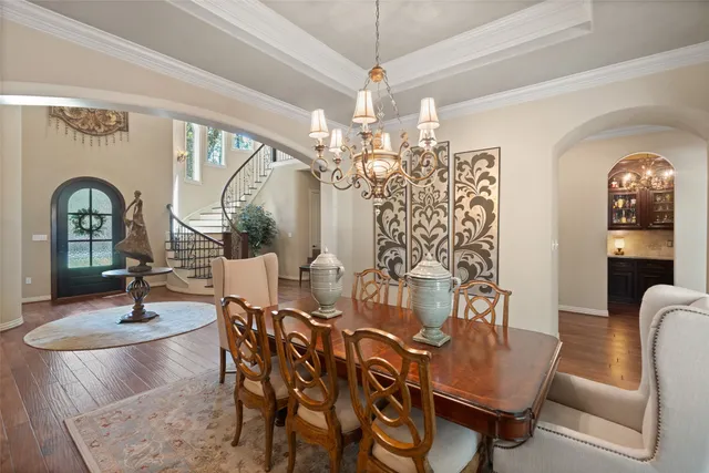 a view of a dining room with furniture and chandelier