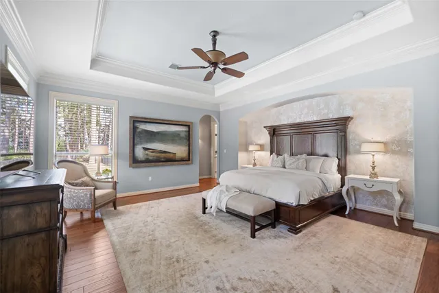 a bedroom with a bed and a chandelier