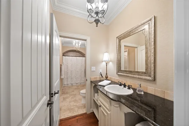 a bathroom with a granite countertop sink a mirror and a shower