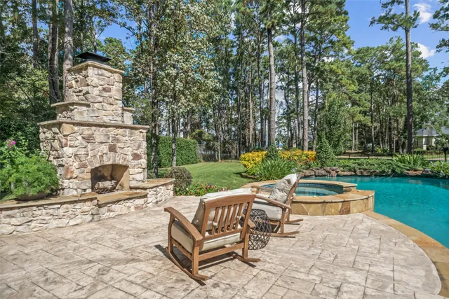 an outdoor sitting area with chairs and a yard