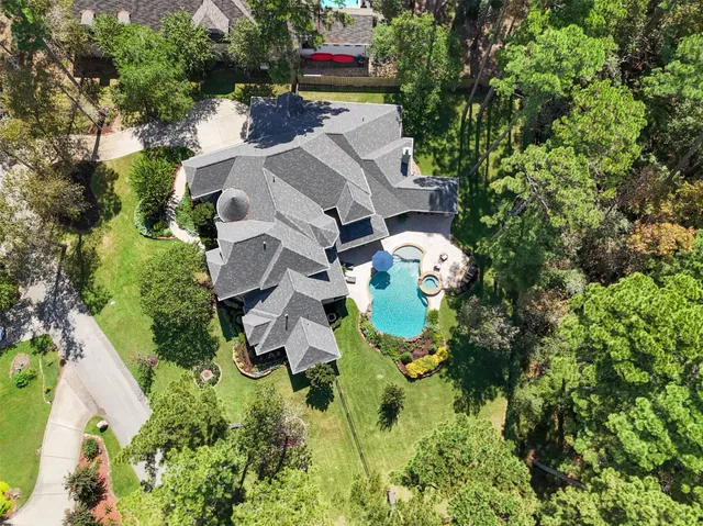 an aerial view of residential house with outdoor space and parking