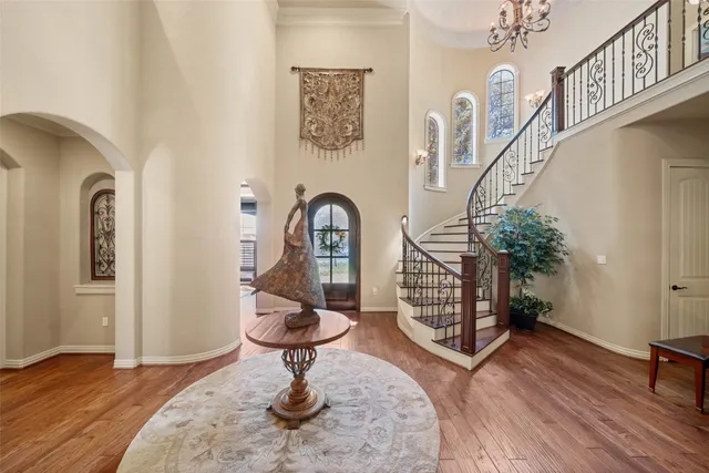 a living room with fireplace furniture a rug and wooden floor