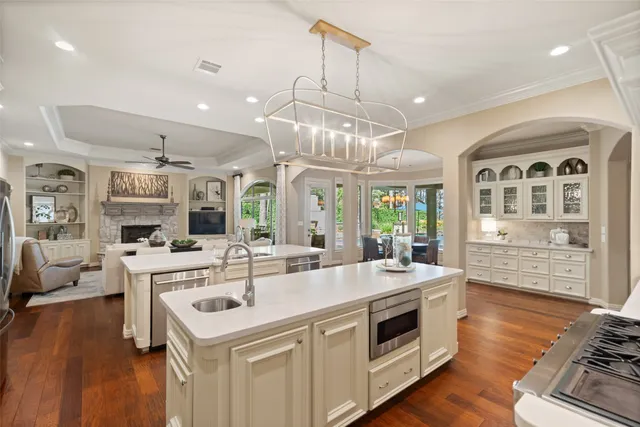 a kitchen with a stove and wooden floor