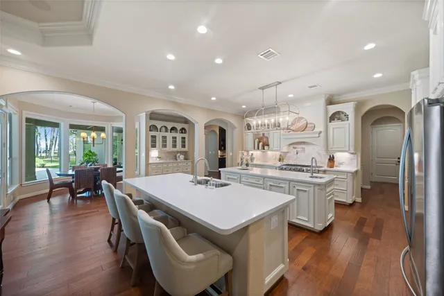 a large kitchen with a table and chairs