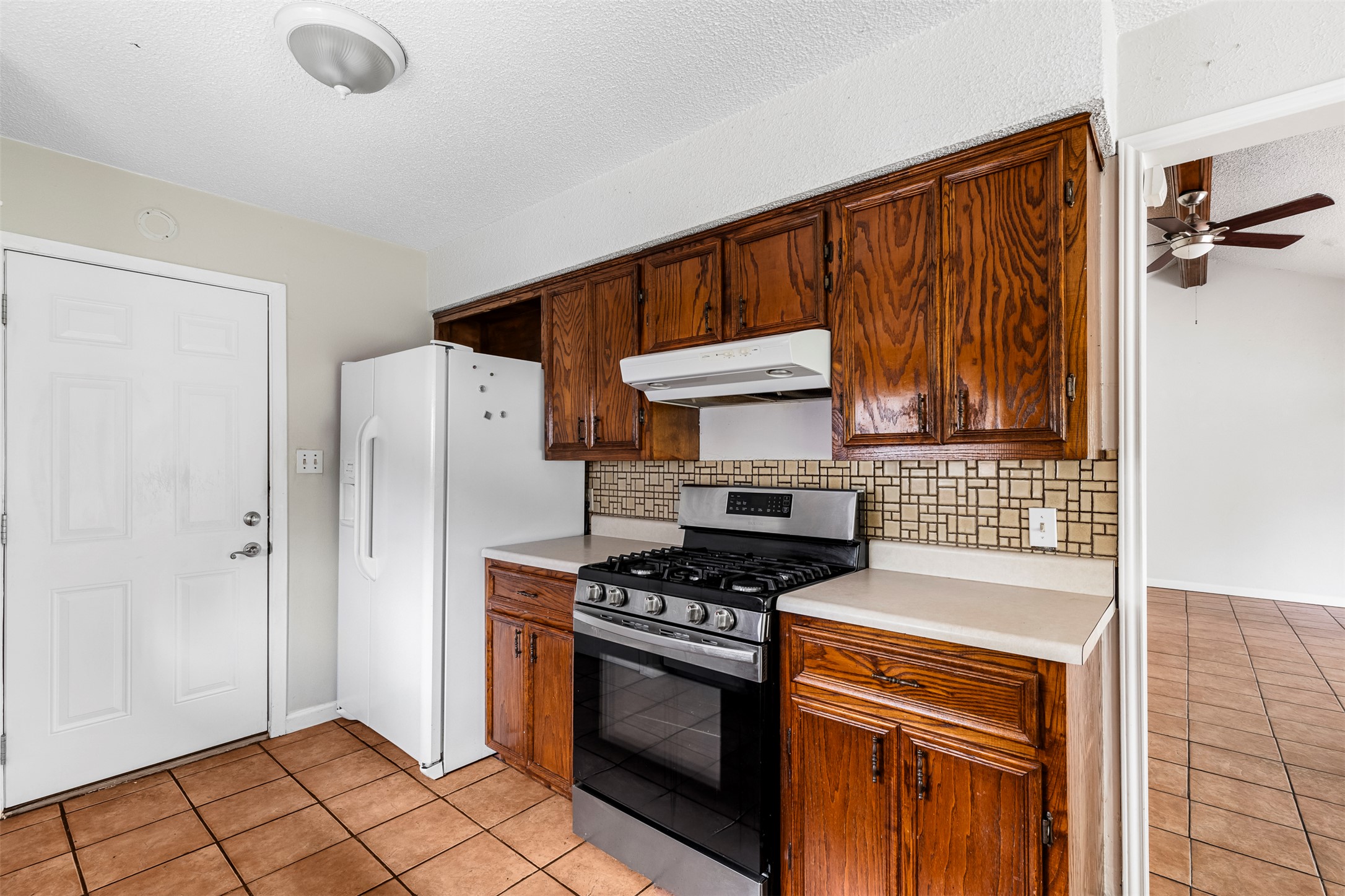 7506 Glenhill Road Austin, TX 78752 - Photo 8 of 24 A functional kitchen provides ample space for culinary pursuits with natural wood cabinetry.