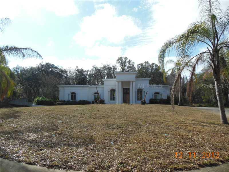 934 Crenshaw Lake Road Lutz, FL 33548 - Photo 1 of 1 a front view of a house with a yard and trees