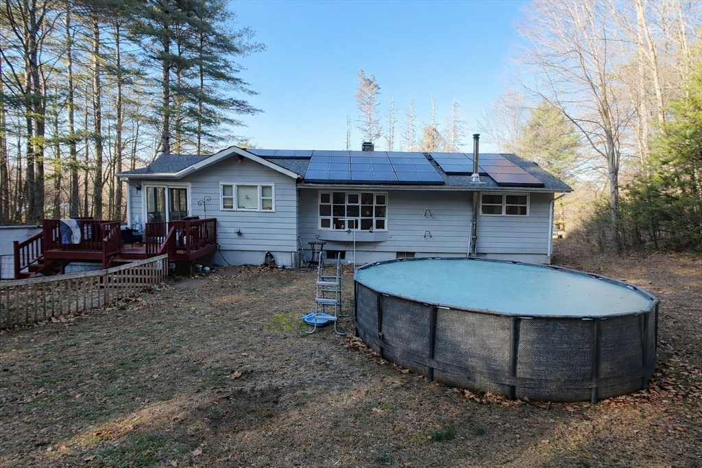 389 West Main Street Dudley, MA 01571 - Photo 3 of 19 a view of a house with a sink and wooden fence