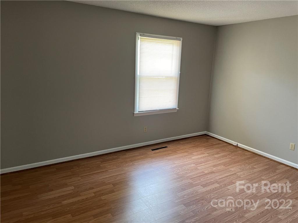 2306 Startown Road Lincolnton, NC 28092 - Photo 6 of 6 an empty room with wooden floor and windows