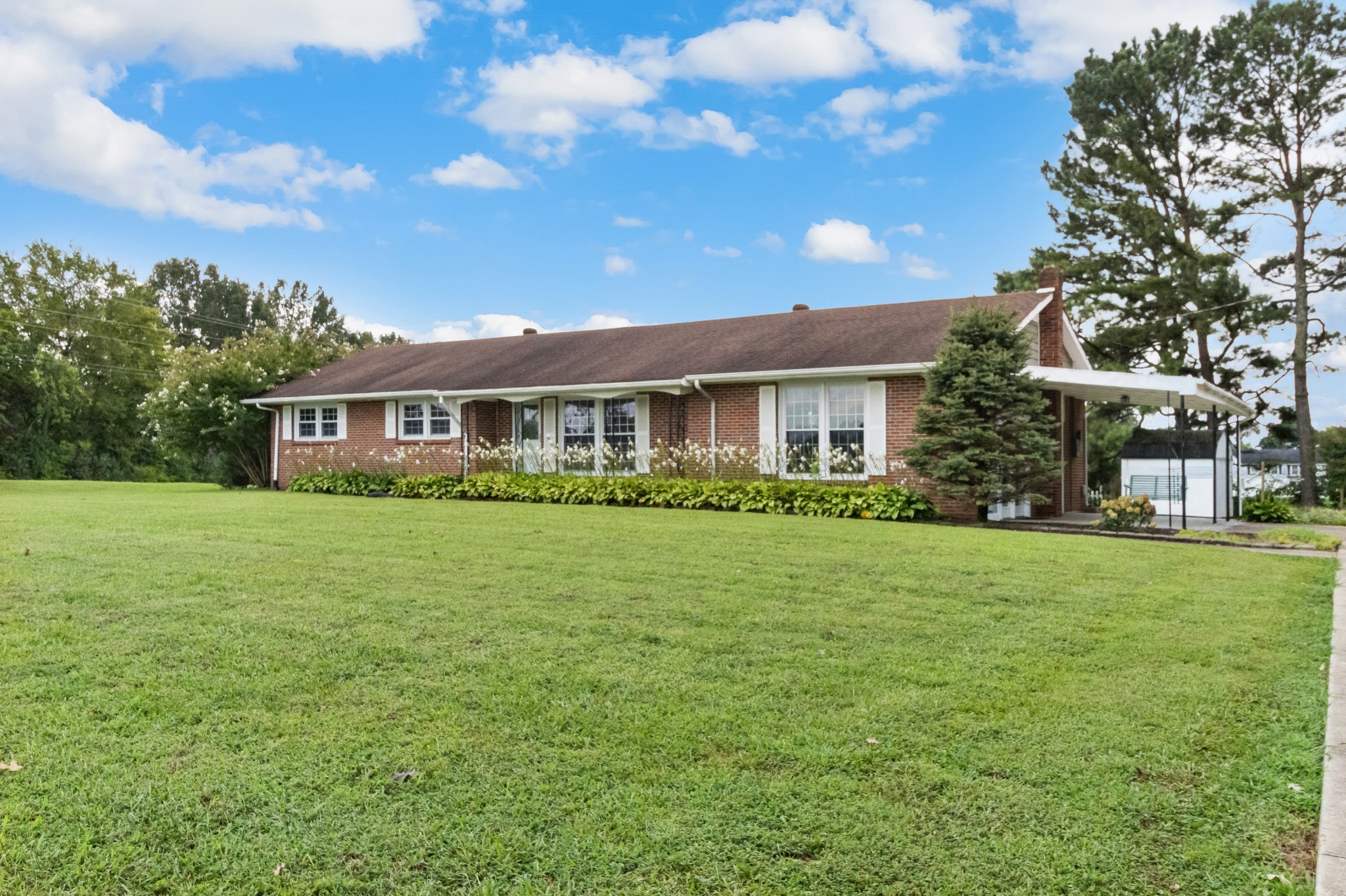 3674 Rossview Road Adams, TN 37010 - Photo 1 of 40 a front view of a house with a garden