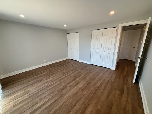 wooden floor in an empty room with a mirror