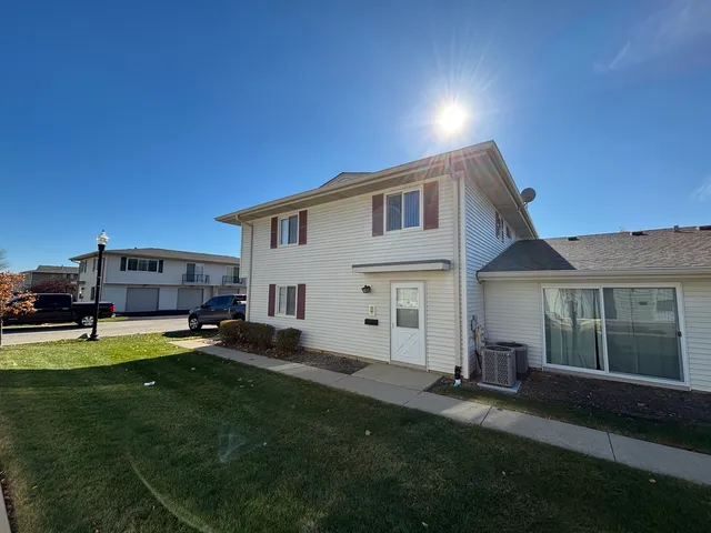 a house view with a sitting space and garden