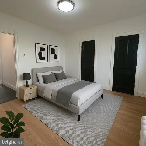 a bedroom with a bed and a painting on the wall