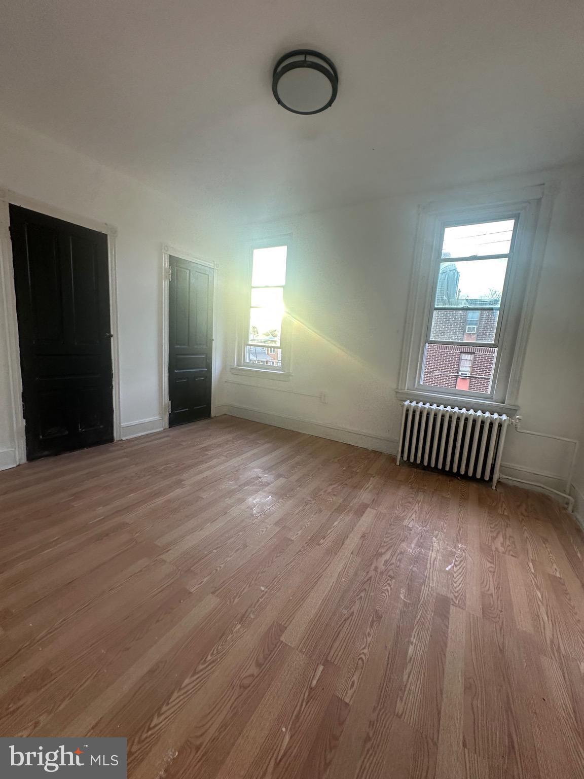 260 West Queen Lane Philadelphia, PA 19144 - Photo 13 of 34 an empty room with wooden floor and windows