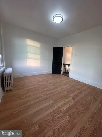 a view of a livingroom with an empty space and a window