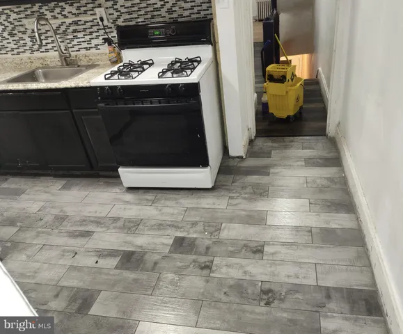 a kitchen with a sink and a stove