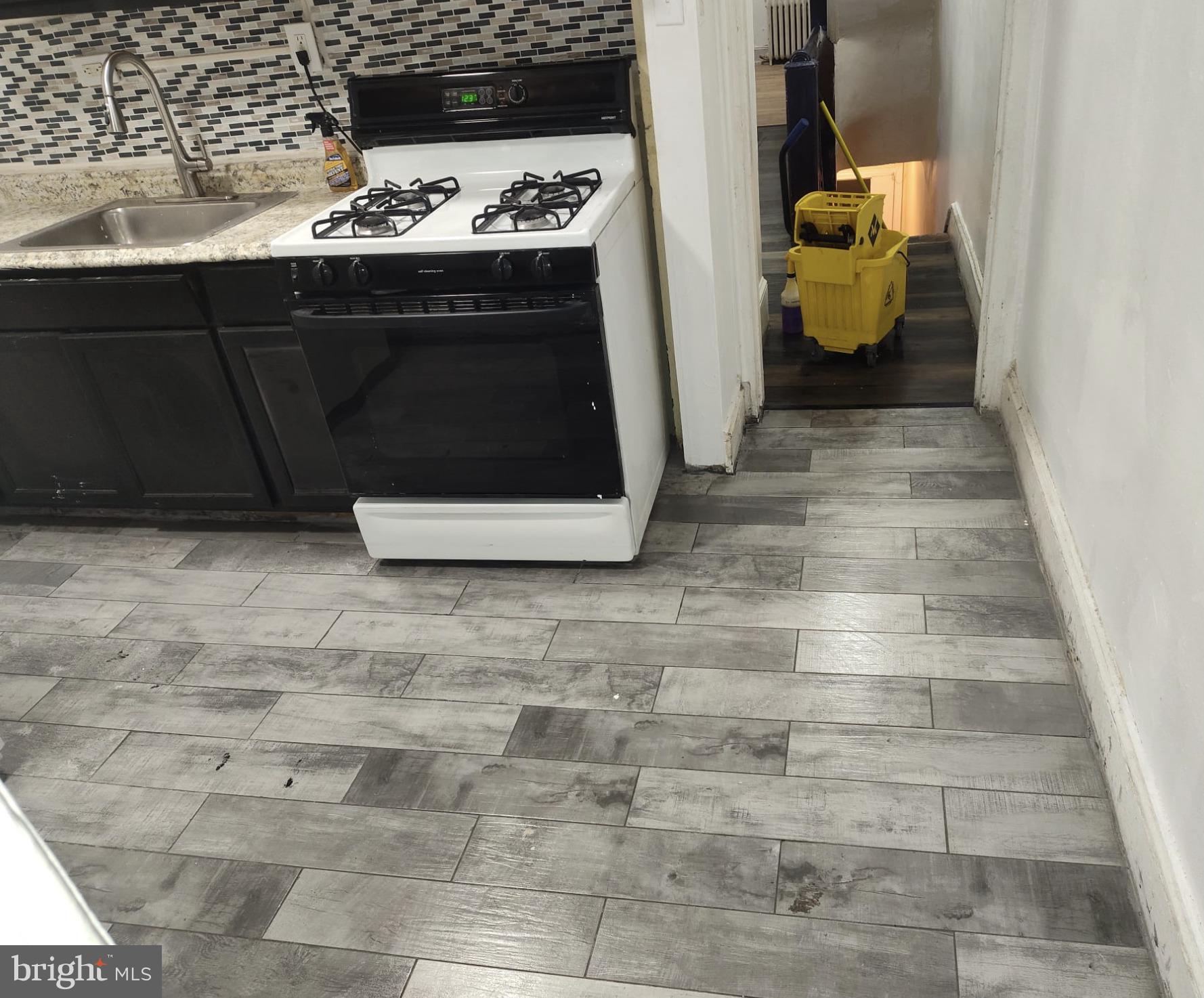 260 West Queen Lane Philadelphia, PA 19144 - Photo 25 of 34 a kitchen with a sink and a stove