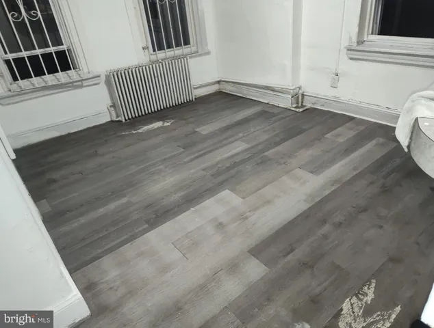 a view of a livingroom with hardwood floor and staircase