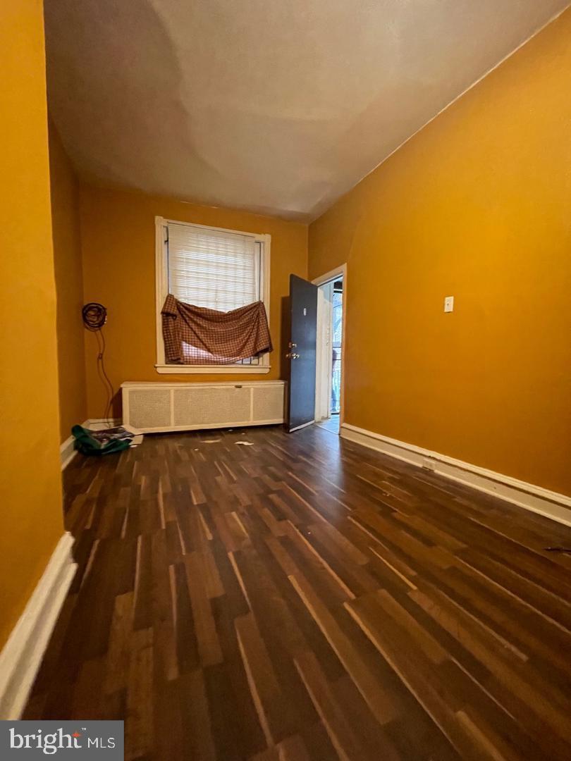 260 West Queen Lane Philadelphia, PA 19144 - Photo 32 of 34 a view of an empty room with a window and wooden floor