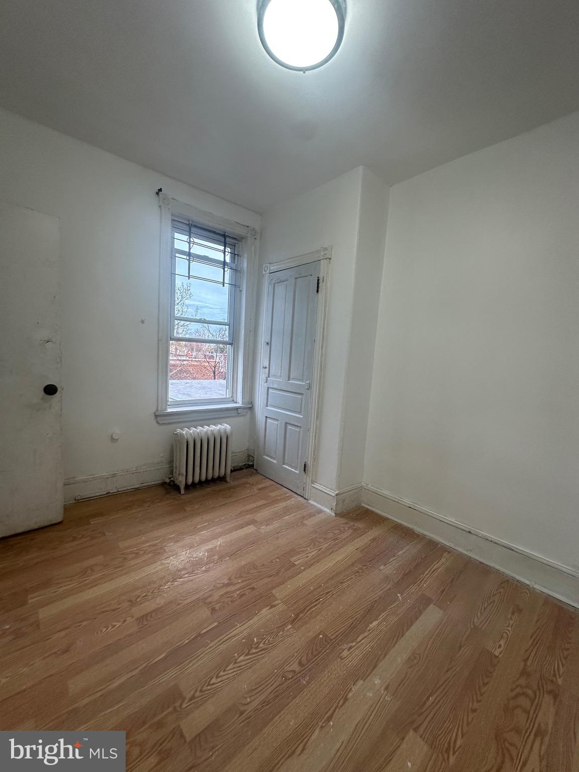 260 West Queen Lane Philadelphia, PA 19144 - Photo 10 of 34 an empty room with wooden floor and windows