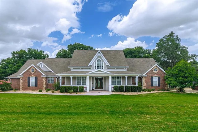 a view of a wooden deck with a chair and flower pot