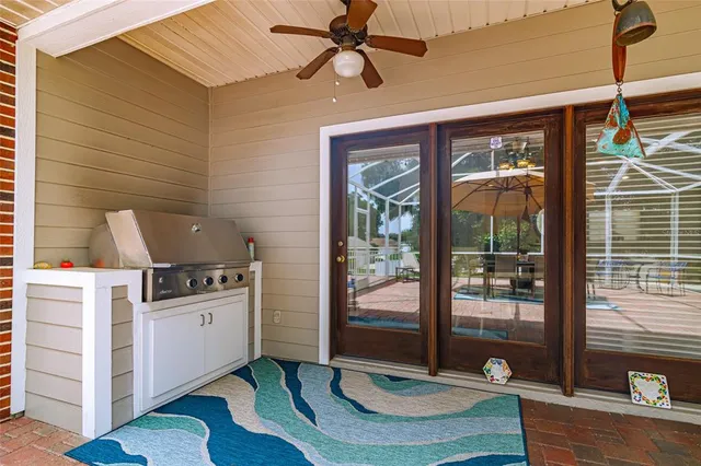 a kitchen with stainless steel appliances granite countertop a sink a stove and a wooden cabinets