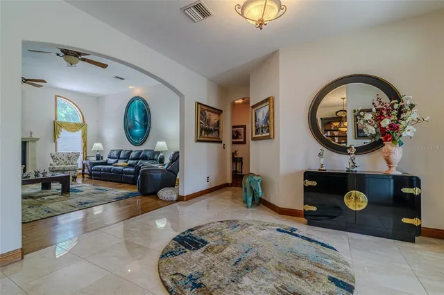 a bedroom with a bed and a flat tv screen on wall