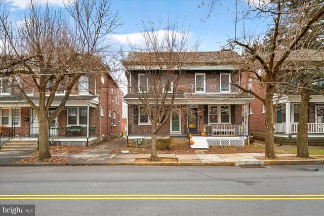 a front view of residential houses with yard
