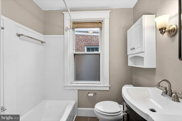 a bathroom with a sink a mirror and a toilet