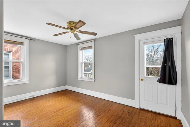 a view of a room with wooden floor and windows