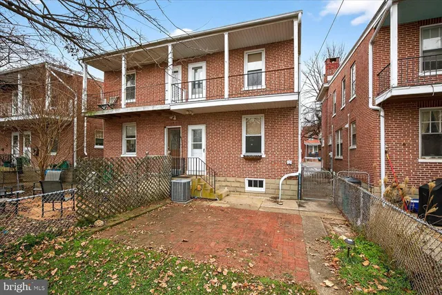 a view of a yard with plants and trees