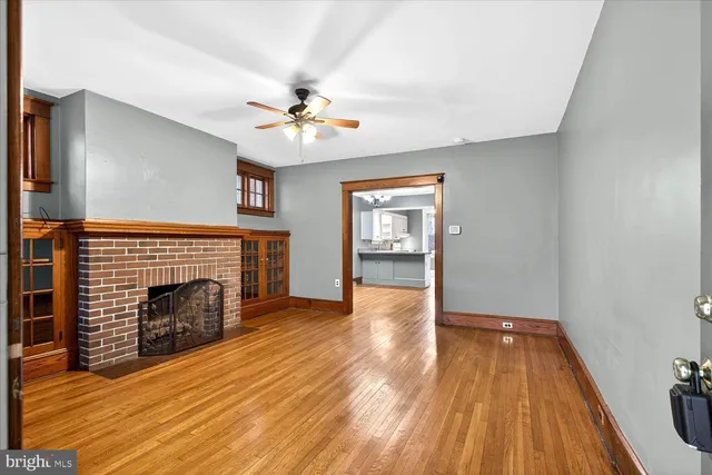 a view of an empty room with a fireplace and a window