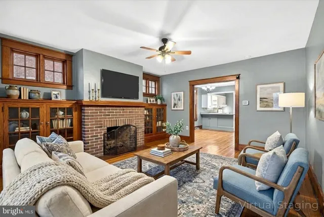 a living room with furniture fireplace and a window